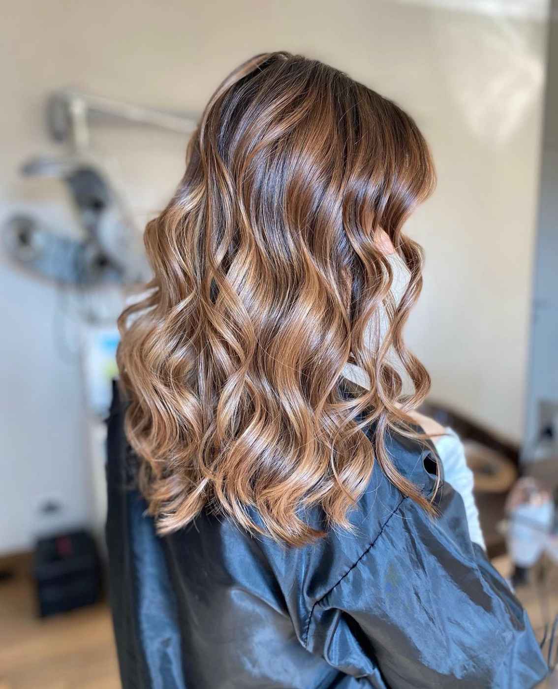 Degradè castano con riflessi caldi e movimento naturale sui capelli